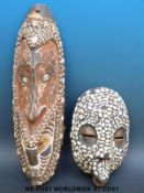 A tribal mask from Papa New Guinea and a small tribal mask set with shells (largest 52cm)