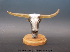 A chrome bull's head car mascot with light up eyes and horns (width 17.