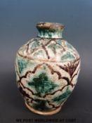 A Persian vase decorated in aubergine and turquoise (18cm tall)