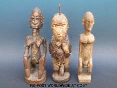 Three African tribal figures one with beaded decoration (tallest 28cm)