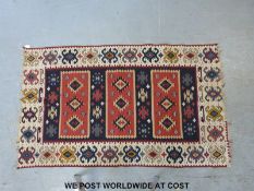 A rug with Aztec style geometric decoration (150cm long x 94cm wide)