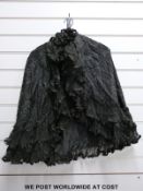 A ladies black evening cloak with beadwork decoration