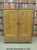 An Ikea pine two door over two drawer cupboard (H132 x W113 x D62cm)