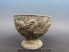 A 19thC Japanese metal pedestal bowl with relief moulded decoration of dragon amongst bamboo (11.