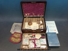A 19thC rosewood and mother of pearl inlaid work or needlework box with fitted interior and lift