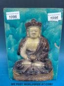 A Chinese Ming Dynasty ceramic tile decorated in relief with Guanyin on blue glazed ground (24 x