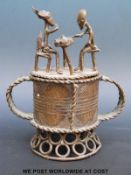 An Ashanti figural cup with two figures playing a game to the top (18cm tall)