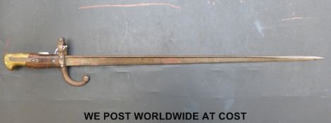 A c1878 French bayonet with the narrow 'T' form blade, wood grips and brass pommel.