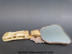 A white metal Chinese mirror with floral and bird decoration,