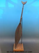 A carved tribal paddle on purpose-built stand (93cm tall)
