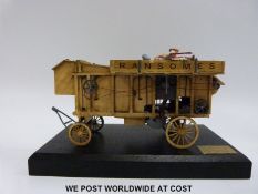 An unnamed probably Bassett-Lowke diecast model Ransomes threshing machine on wooden display plinth.