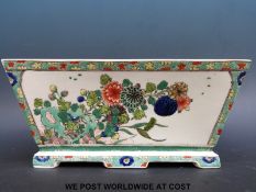 A Chinese flower trough of graduated rectangular form decorated in green,