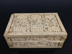 A 19thC Chinese carved ivory cribbage board which when folded forms a box for playing cards and