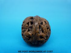 A Japanese Meiji period walnut netsuke with carved decoration