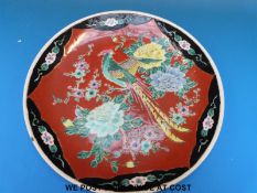 A Japanese charger decorated with a bird amongst peonies circa 1920s (31cm diameter)