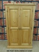 A two door pine cupboard (H140 x W86 x D48cm)
