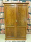 A Georgian flame mahogany wardrobe with panel doors and dentil cornice (W105 x H168 x D53cm)