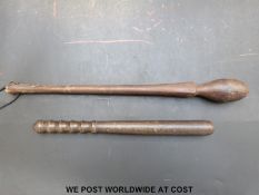 A tribal carved wooden club,