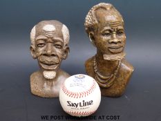 A pair of carved African soapstone busts and a Seoul Olympics baseball