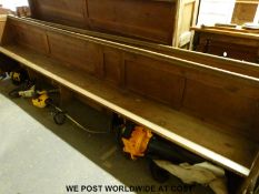 An oak church pew with linen fold end,