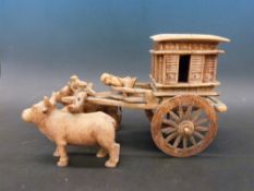 An Indian carved model of a oxen drawn carriage with lift off lid and working shutters