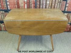 A light elm Ercol table (L112 x W126 x H72cm) and four chairs with cross stick backs