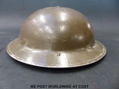 A 1939 WWII British Army helmet, named to inner rim 'G.D.