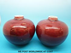 A pair of Chinese Sang de Boeuf red/ burgundy glazed porcelain vases with four character mark to