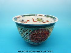 An 18th/19thC Chinese famille vert tea bowl with open lattice work with another layer of blue and