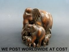 Carved wooden elephant group (11cm tall)
