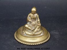 A 19thC small brass / bronze of a seated Buddhist monk, height 4.