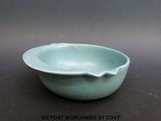 A porcelain dish with five stand marks to the base