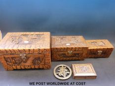 A set of three graduated Chinese carved wooden boxes together with an inlaid box and a Chinese