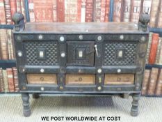 An oriental / far eastern cabinet raised on turned legs with pierced cupboards decorated with small