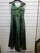 A vintage suitcase containing a c1940 lace wedding dress (size 34), cocktail dress (size 32),