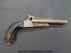 Double barrelled side by side pinfire hammer action pistol with carved grip, engraved locks,