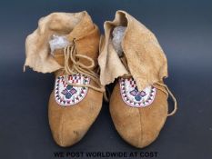 A pair of native American beaded moccasins