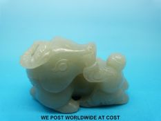 A Chinese carved jadeite water buffalo with two boys on its back (length 6.