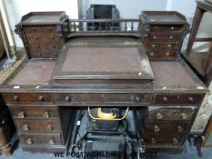 A 19thC burr walnut clerk's pedestal desk with Wellington chests to top and sloping writing surface