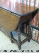 An antique oak drop leaf table of peg-jointed construction (W110 (maximum W115) H68cm)