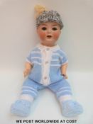 Heubach Koppelsdorf bisque headed doll with open mouth, moving tongue,