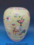 A 19thC Chinese lidded vase / ginger jar with antique and floral decoration on a yellow ground