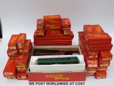 Over 40 Tri-ang 00 gauge carriages and wagons including an Operating Royal Mail coach set,