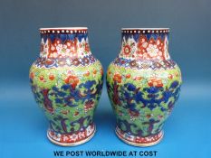 A pair of 18th / 19thC Chinese clobbered vases (18cm tall)