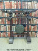 A large early 20thC Burmese gong in carved hardwood frame with elaborate dragon decoration (128cm