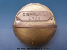 A brass and copper wall mountable cigarette ends holder