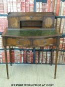 A mahogany bonheur du jour with gilt and tooled leather inset top raised on reeded tapering legs
