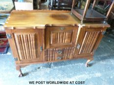 A mahogany / hardwood sideboard with central drinks cabinet raised on cabriolet ball and claw feet