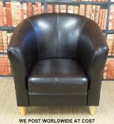 A brown leather tub chair