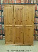 A three door pine wardrobe (H179 x W133 x D55cm)